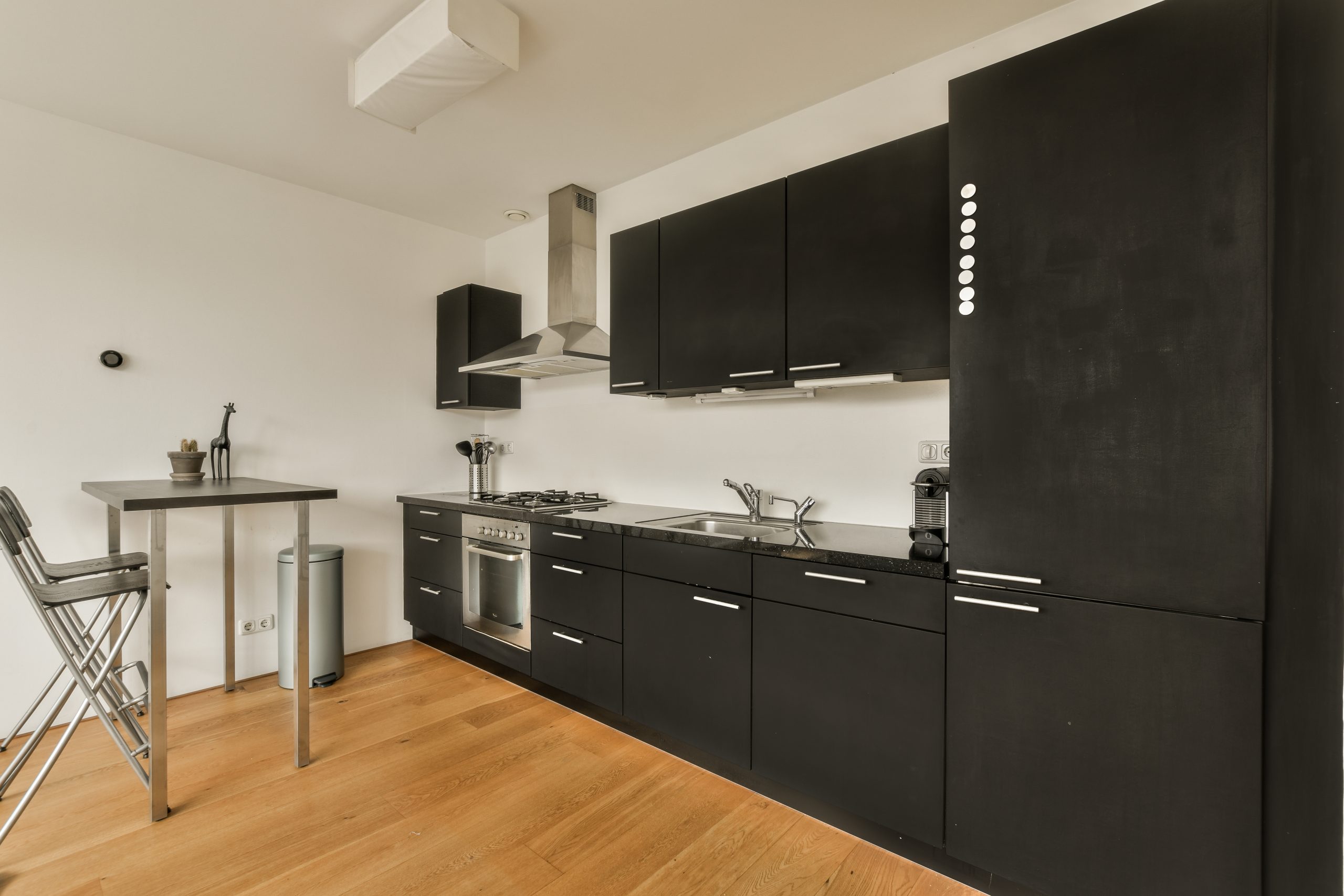 a kitchen with black cabinetry and a counter top