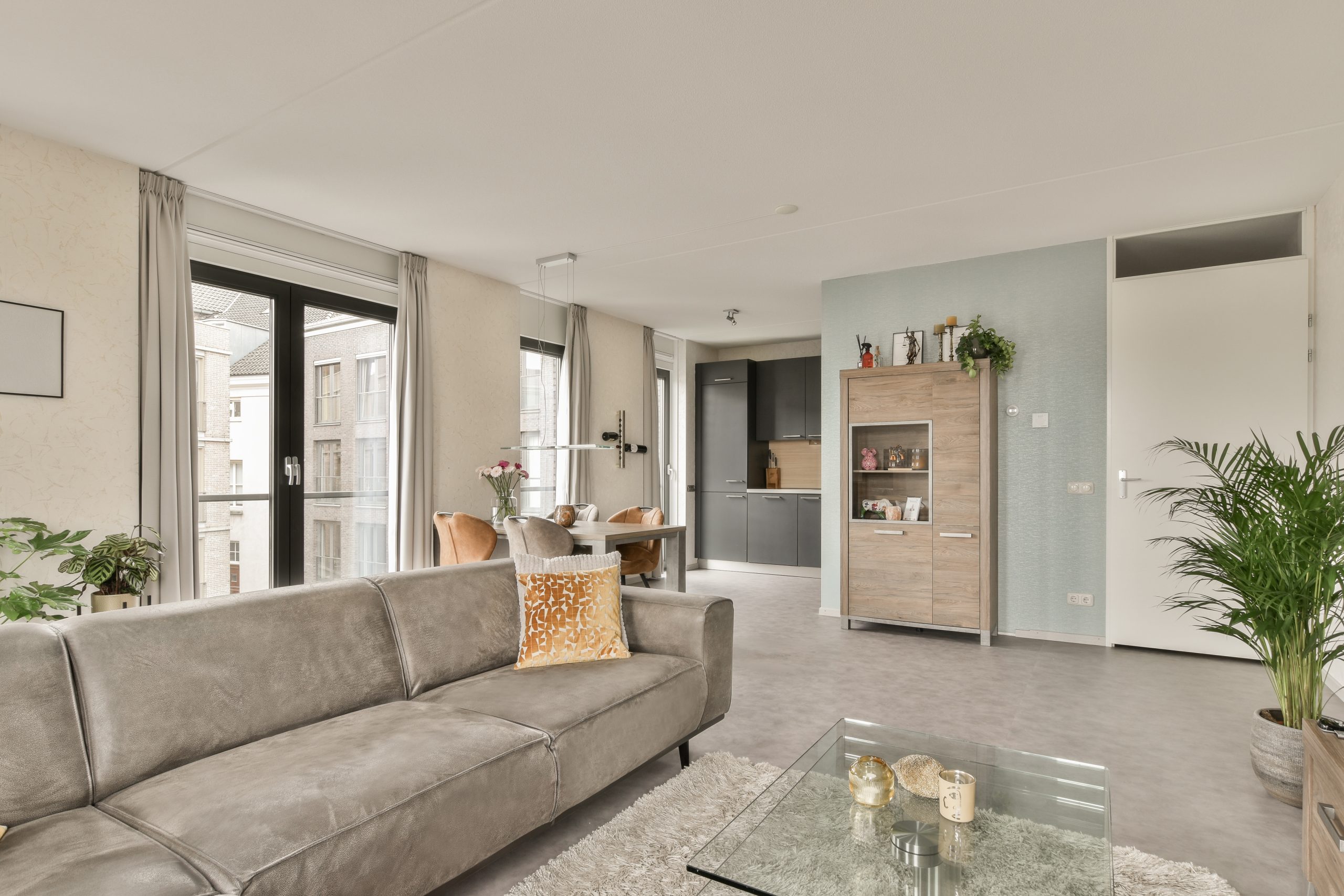 a living room with a couch and a glass table